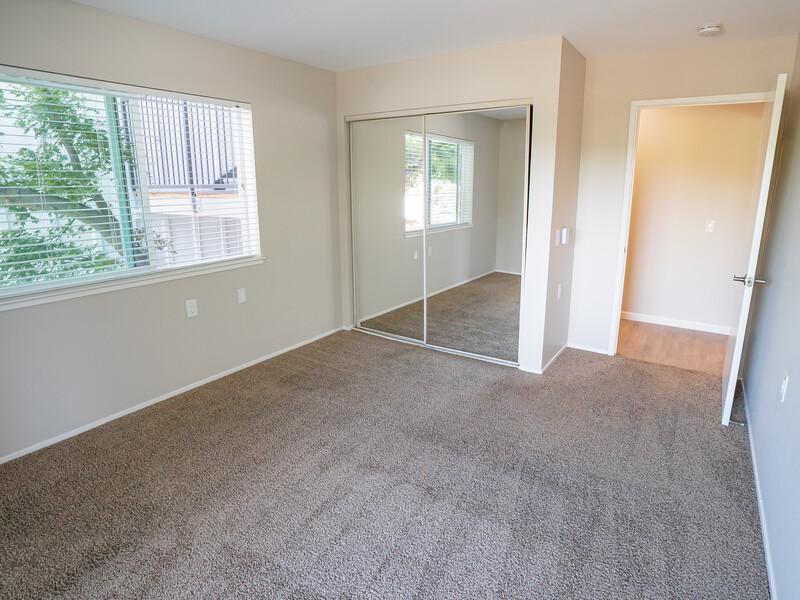 1 BR Apartments in San Rafael CA - McInnis Park - Bedroom with Plush Carpeting and a Mirrored Closet
