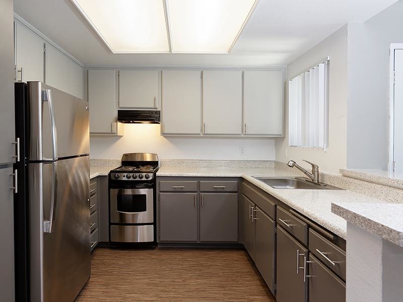Senior Apartments in Santa Fe Springs CA - Costa Azul Senior - Kitchen with Wood-Style Flooring and Stainless Steel Appliances