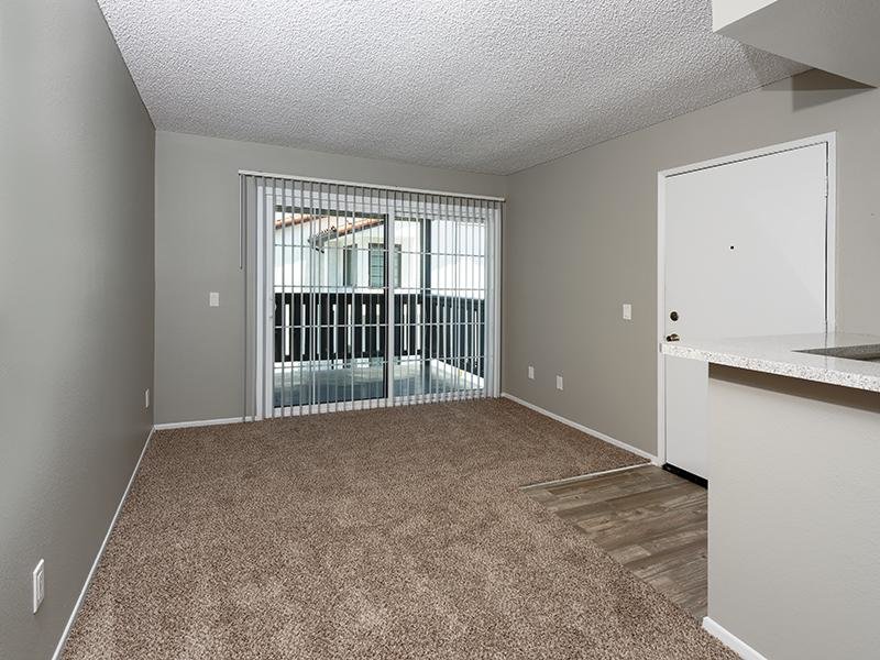 Senior Living in Santa Fe Springs - Costa Azul Senior - Living Area With Plush Carpeting And A Sliding Glass Door to The Patio