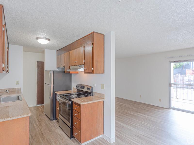 Berkeley, CA Apartments - Kitchen With Stainless-Steel Appliances, Wooden Cabinets, And Wood-Style Flooring.