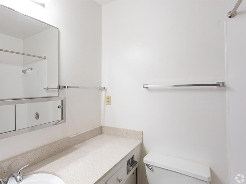 Apartments Near UC Berkeley - Bathroom With Spacious Countertops, White Walls, And Large Mirror