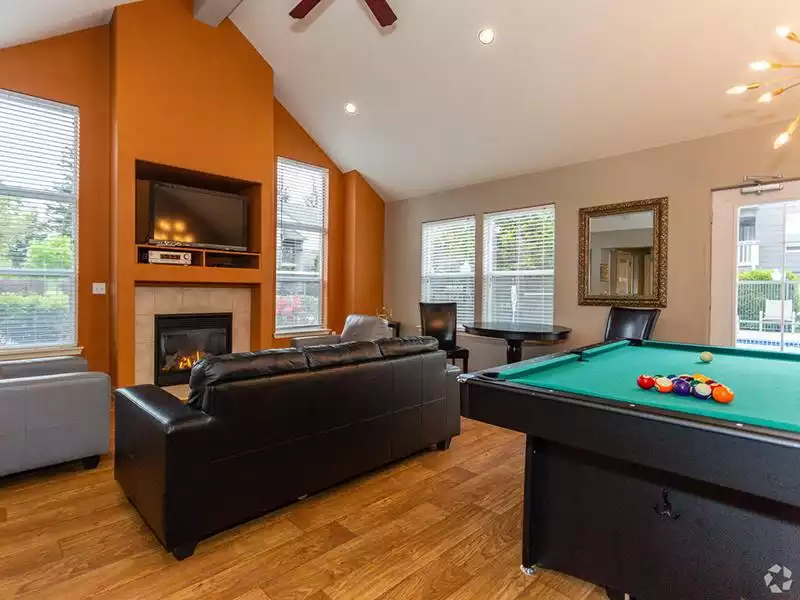 Apartments in Gresham, OR - Stark Street Crossings Club House with Billiards Table, TV, and a Fireplace