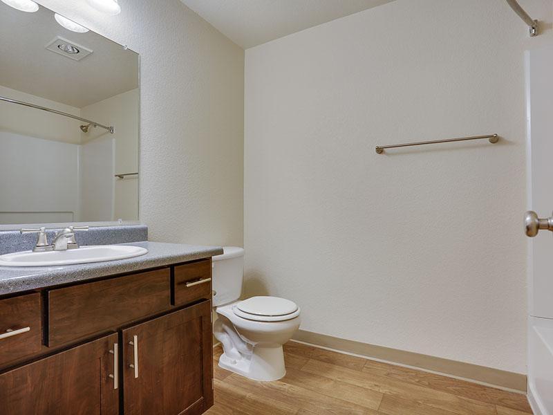 Apartments in Gresham - Stark Street Crossings Bathroom with Wood Style Flooring and Single Sink Vanity