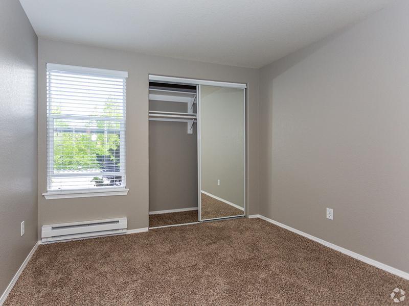Gresham, OR Apartments for Rent - Stark Street Crossings Bedroom with Spacious Closet and Plush Carpet Flooring