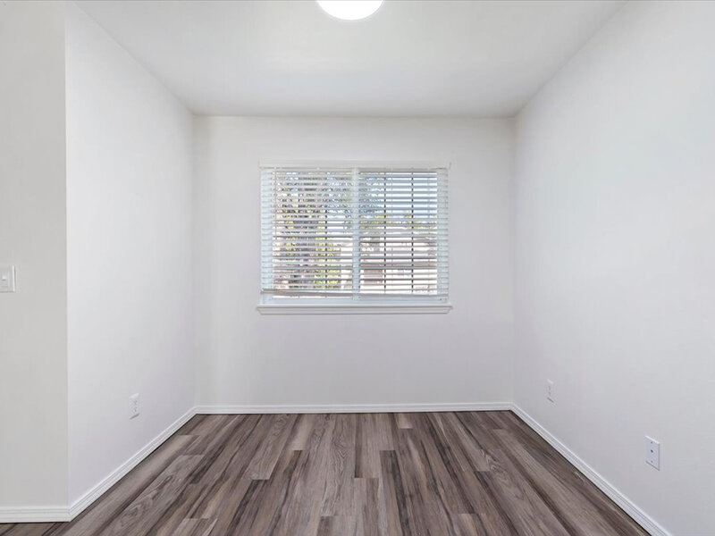 Room with Wood Like Flooring | Spring Creek Apartments