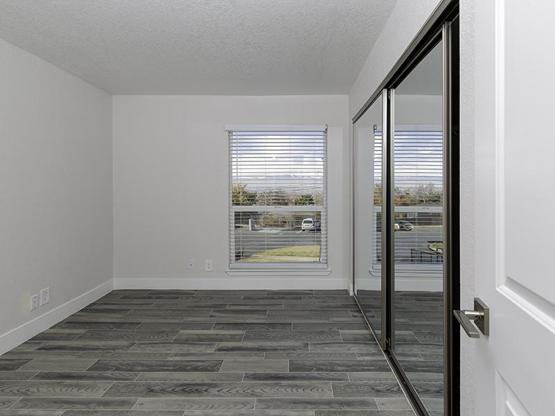 Luxury One Bedroom Apartments in Salt Lake City UT - Foothill Place - Bedroom with Wood-Style Flooring and a Mirrored Closet