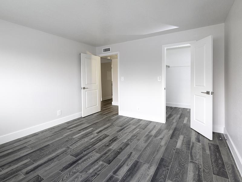 Apartments for Rent in Salt Lake City - Foothill Place Apartments Spacious Bedroom with Gray Wood Flooring and Walk-in Closet