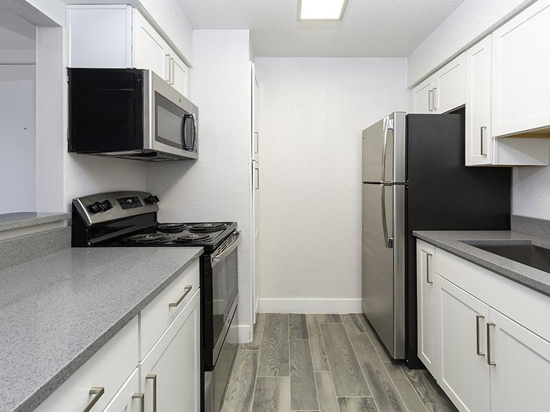 Luxury Apartments in Salt Lake City UT - Foothill Place - Modern Kitchen with Wood-Style Flooring and Stainless-Steel Appliances