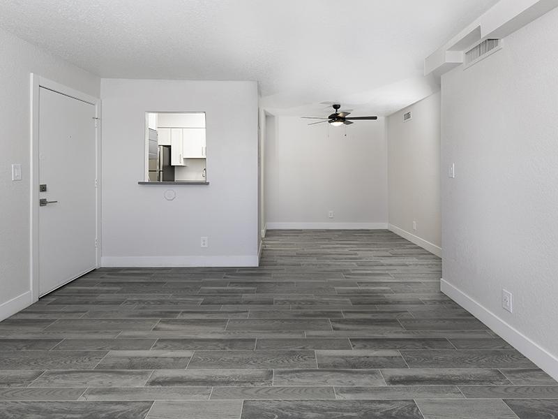 Apartments for Rent in Salt Lake City UT - Foothill Place - Living Room with Ceiling Fan, Wood Flooring, & Kitchen Dining Area