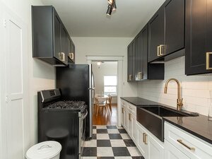 Kitchen with Black Cabinets and Appliances | Hillcrest Apartments in Salt Lake City, UT