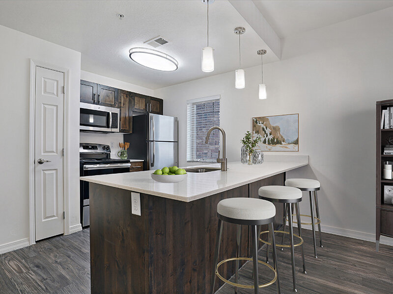 Kitchen with Hanging Ceiling Lights and Stools at Kitchen Counter | Wasatch Commons