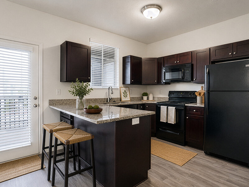 Kitchen with Stools and Ceiling Light | Eastgate at Greyhawk