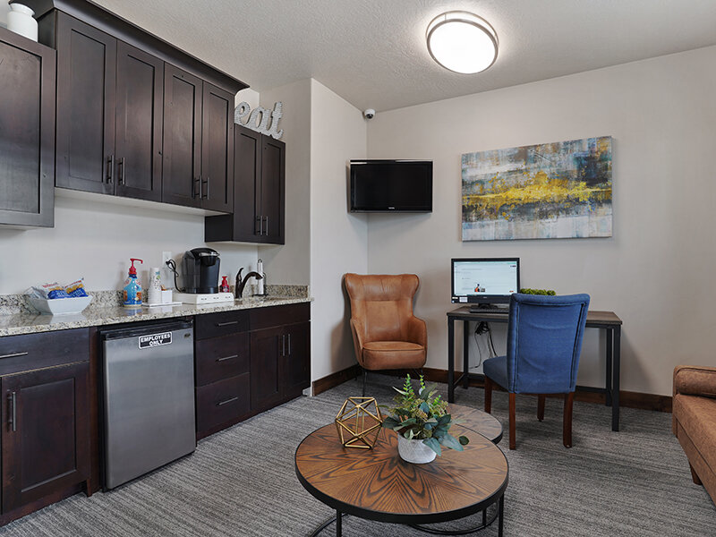 Community Kitchen with Coffee Table and Television | Eastgate at Greyhawk