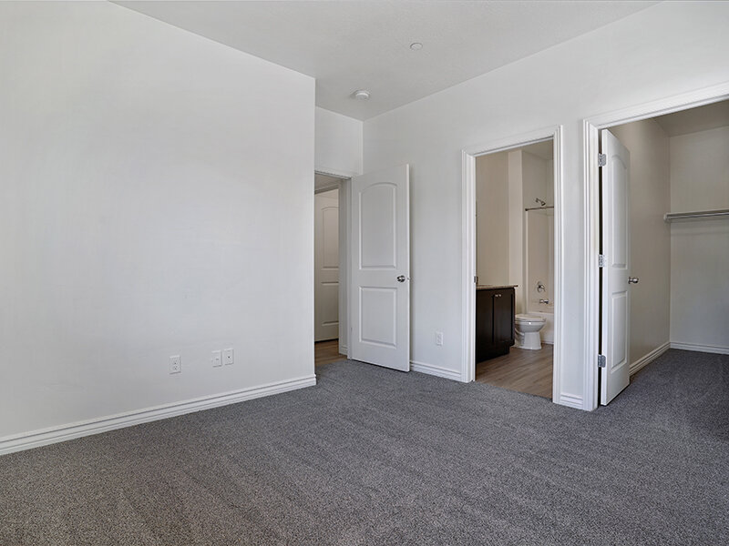 Bedroom with Carpeted Floors and Entrance to Bathroom | Eastgate at Greyhawk