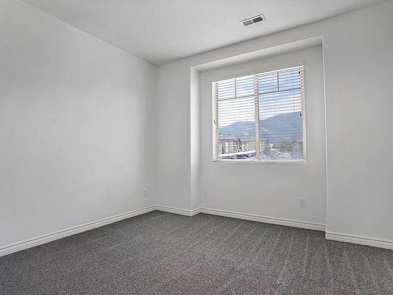 Bedroom with Window and Carpeted Floors | Eastgate at Greyhawk