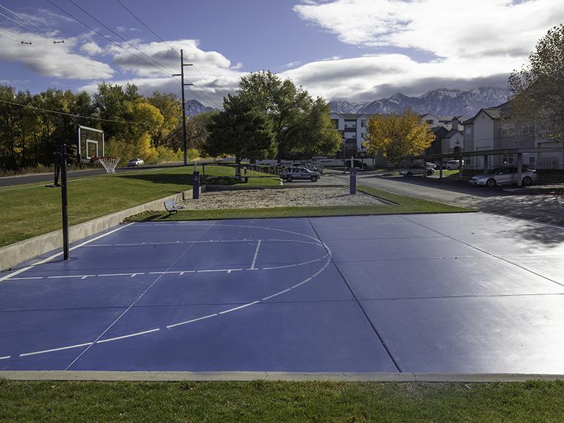 Apartments In Sandy For Rent - Alpine Meadows - Outdoor Basketball Court With Apartment Homes In The Background.