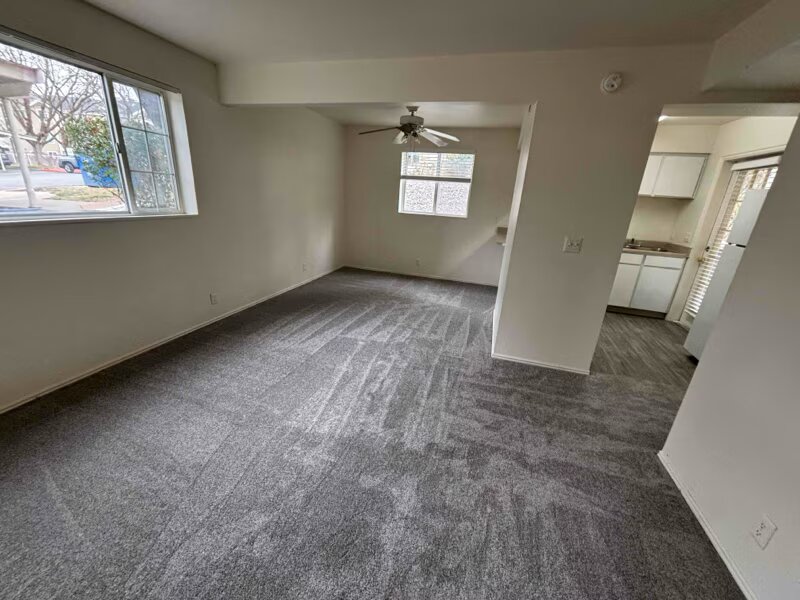 Living Room with Kitchen and Carpeted Flooring | Woods Crossing