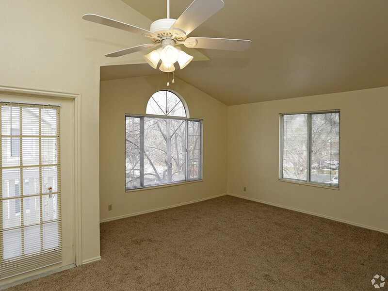 Living Room with Carpeted Flooring and Ceiling Fan and Windows | Woods Crossing