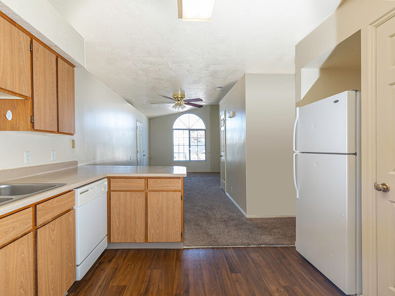Kitchen with Wood Style Flooring and Cabinets and Ceiling Fan | Woods Crossing