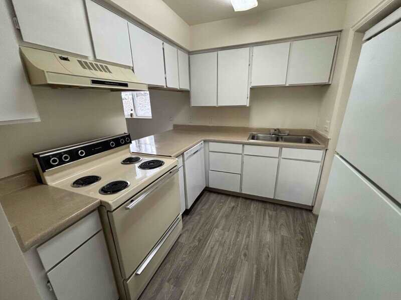 Kitchen with Cabinets and Wood Style Flooring | Woods Crossing