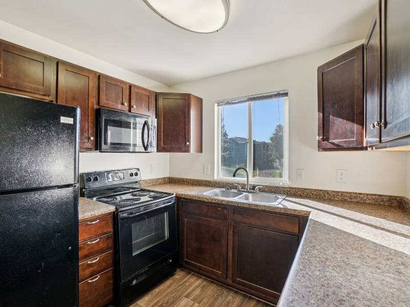 Kitchen with Black Appliances | Village Park Apartments