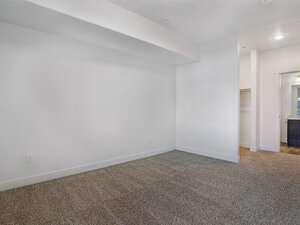Bedroom with Carpeted Flooring and Bathroom Entrance | Mill Point