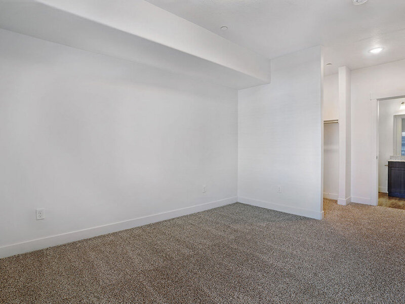 Bedroom with Carpeted Flooring and Bathroom Entrance | Mill Point