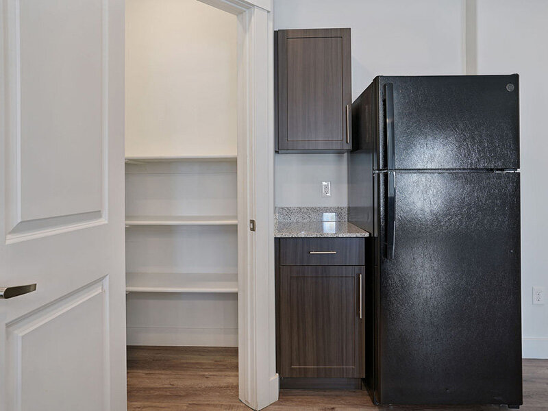 Kitchen Pantry with Fridge and Wood Style Flooring | Mill Point