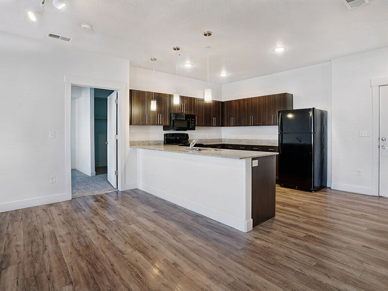 Kitchen with Marble Styled Countertops and Wood Styled Floors | Mill Point