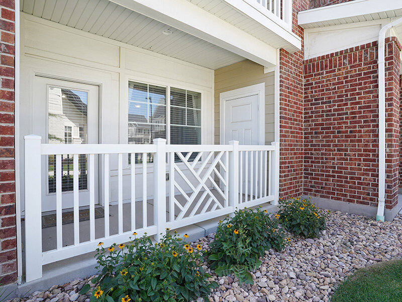 Exterior Views with Patio and White Railing | Draper Village