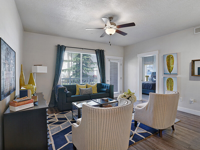 Living Room with Ceiling Fan amd Seating | Draper Village