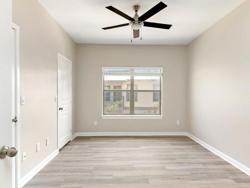 Large Bedroom with a Ceiling Fan | The Niche Apartments