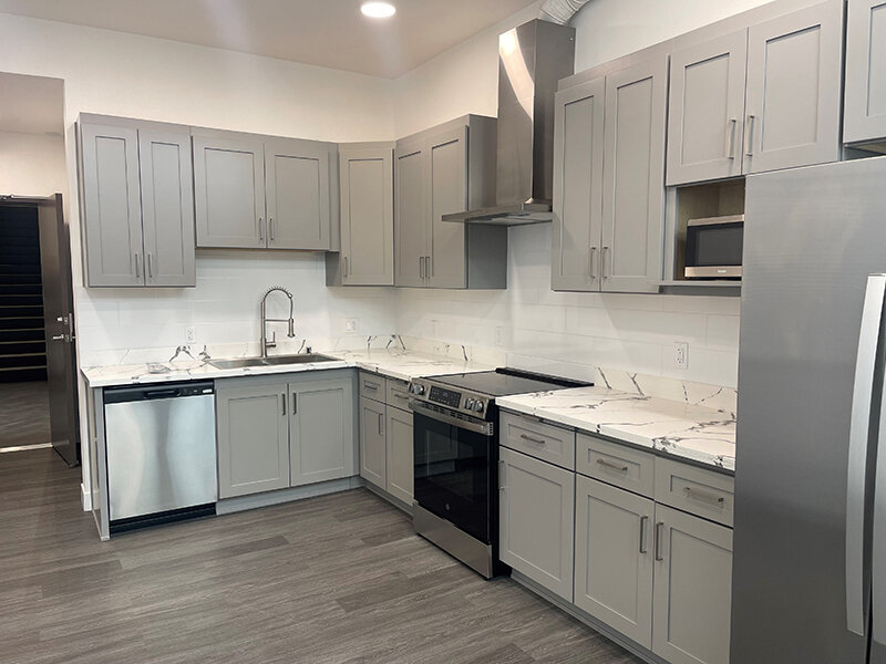 Kitchen with Wood Style Flooring and Cupboards | Pacific Place Apartments