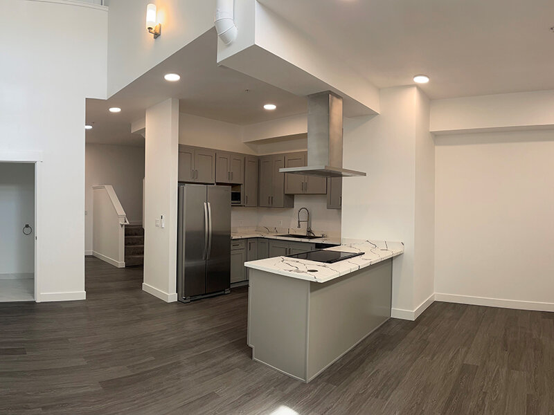 Kitchen with Stairwell and Wood Style Flooring | Pacific Place Apartments