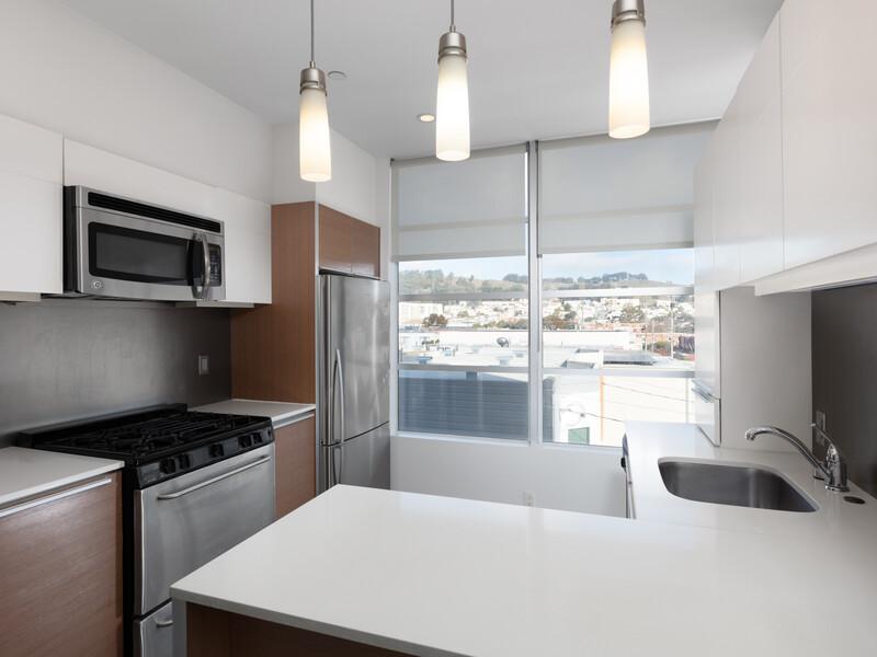 Apartments For Rent in Daly City, CA - Pacific Place - Kitchen with White Countertops, Stainless Steel Appliances and a Window
