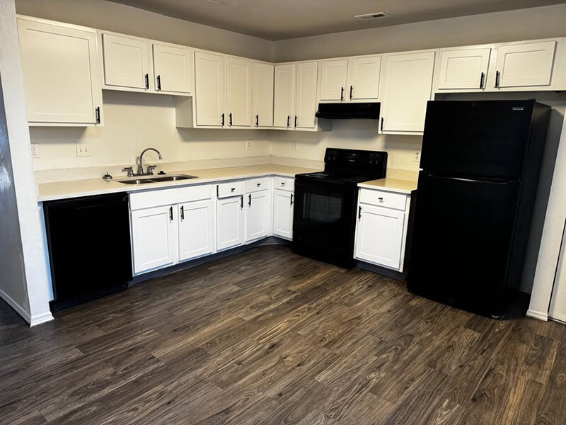 Kitchen Appliances with Wood Style Flooring and Cupboards | Mulberry Park
