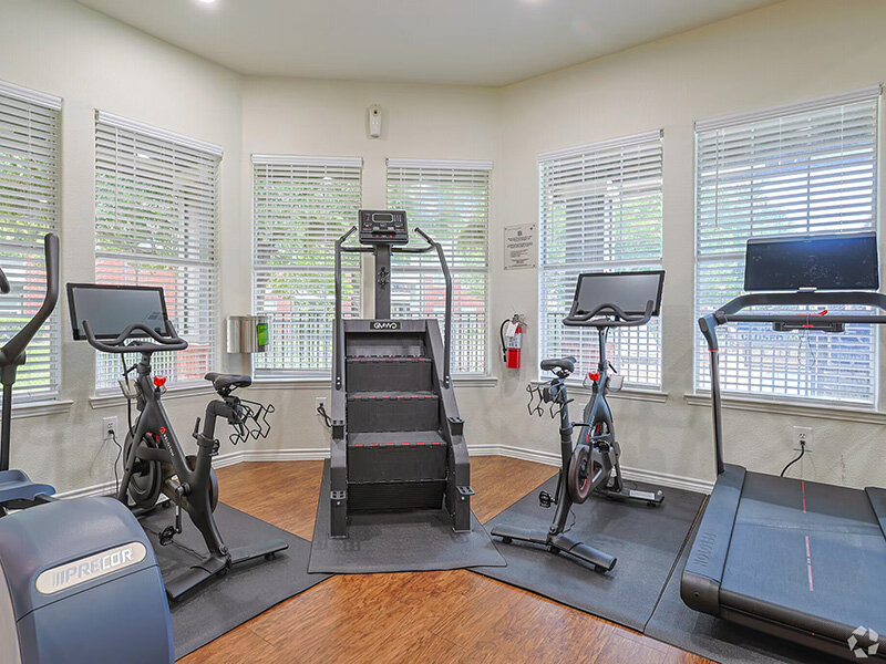 Community Exercise Room with Windows and Wood Style Flooring | Oaks at Georgetown