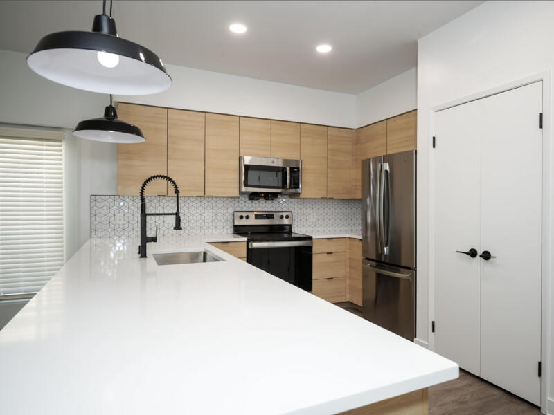 Studio City Apartments For Rent - The Thomas - Fully Equipped Kitchen With Stainless Steel Appliances, Dishwasher, And Wood-Style Flooring.