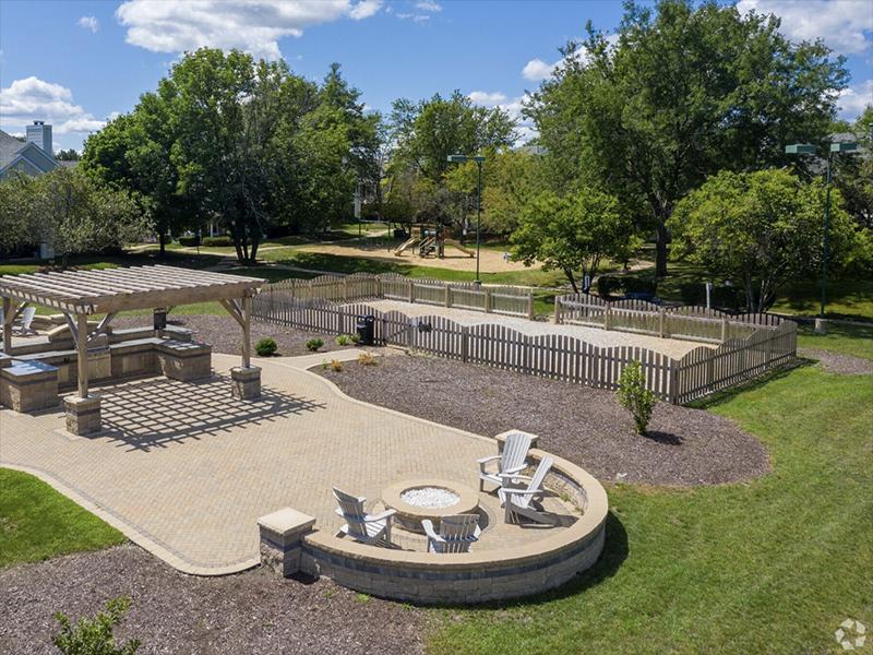 Apartments in Naperville - Arbors of Brookdale - Firepit Lounge Area with Chairs, Grill, and Dog Area