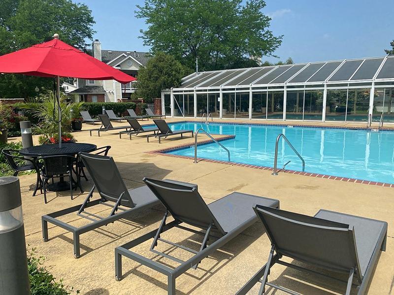 Apartments in Naperville for Rent - Arbors at Brookdale - Sparkling Pool, Sun Lounge Chairs, and Outdoor Furniture