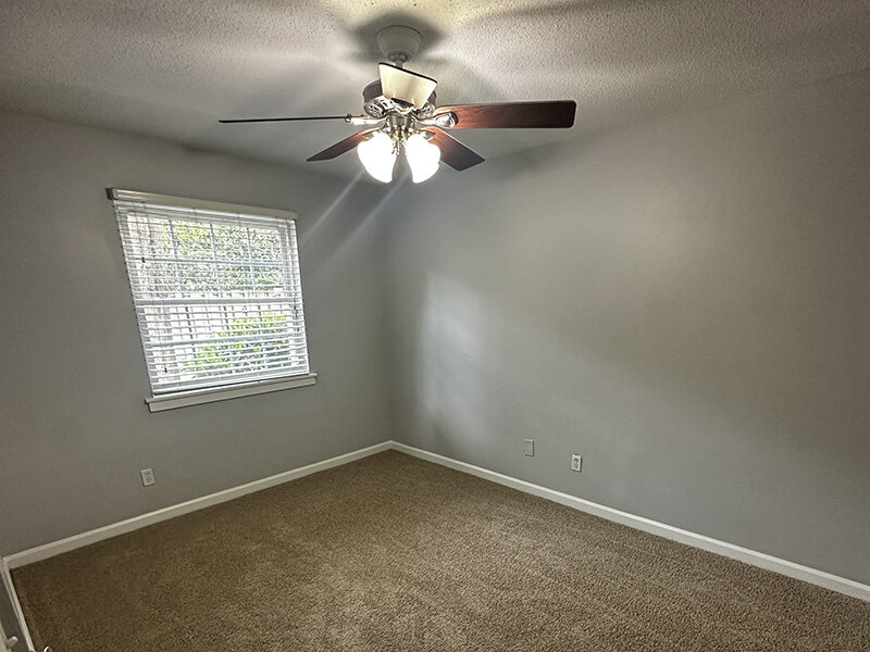 Bedroom with Ceiling Light and Fan with Window | Ashland Commons Apartments