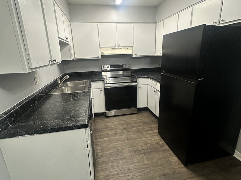 Kitchen with Cabinets and Wood Style Flooring | Ashland Commons Apartments