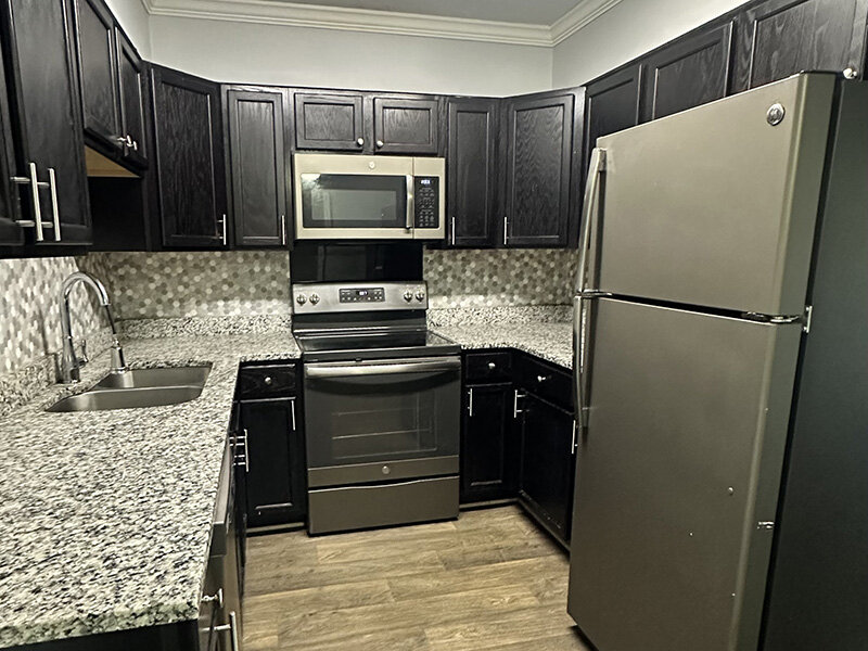 Kitchen with Wood Style Flooring and Cabinets with Wood Style Flooring | Ashland Commons Apartments