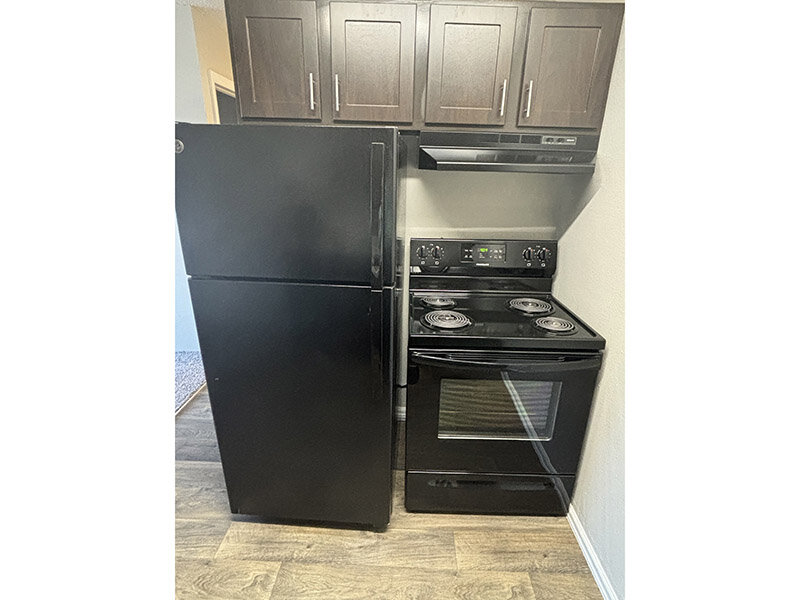 Kitchen with Black Appliances | Airlan Arms