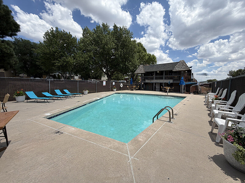 Community Outdoor Pool with Lounge Deck Seating and Foliage | Spring Creek