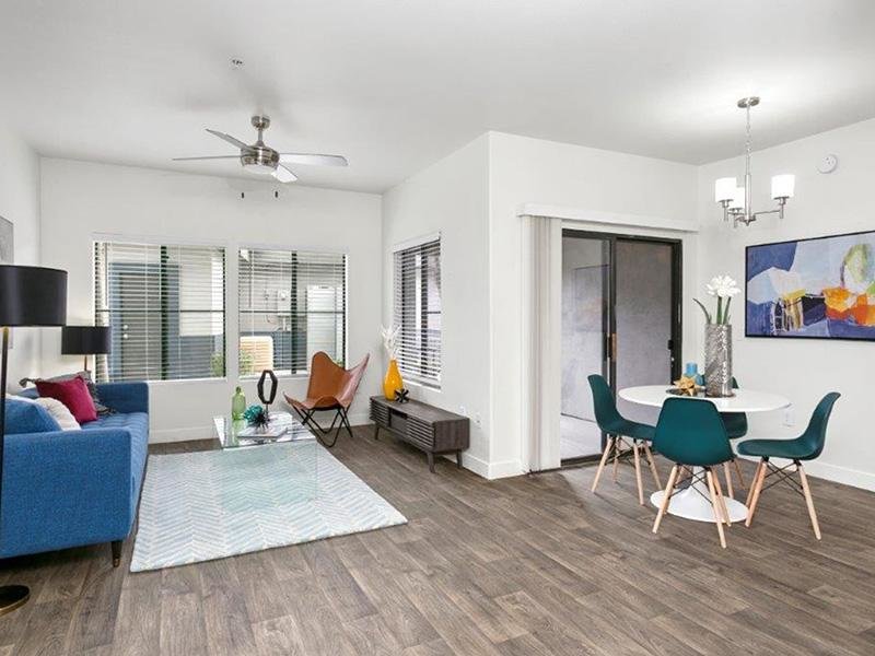 Apartments for Rent in Phoenix AZ - Portola South Mountain - Open Concept Living Room with Wood Plank Flooring, Attached Dining Area, Glass Sliding Pa