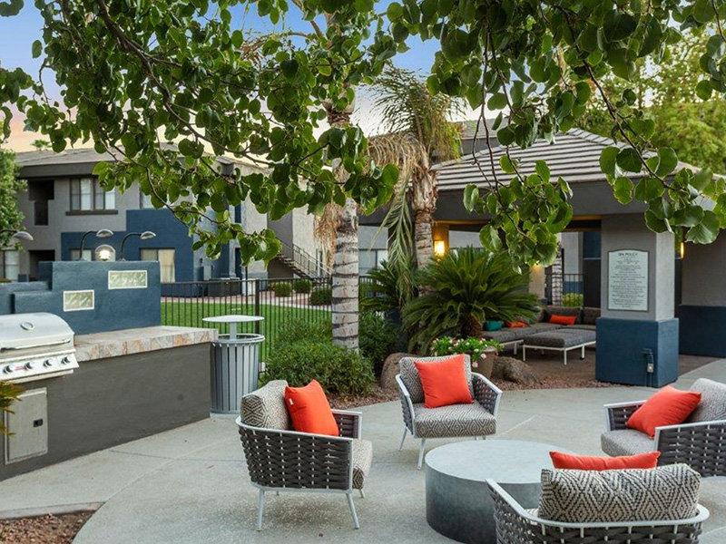 Pet Friendly Apartments in South Mountain AZ - Portola South Mountain - Relaxing Outdoor BBQ Area with Grill Station, Lounge Seating, and Greenery