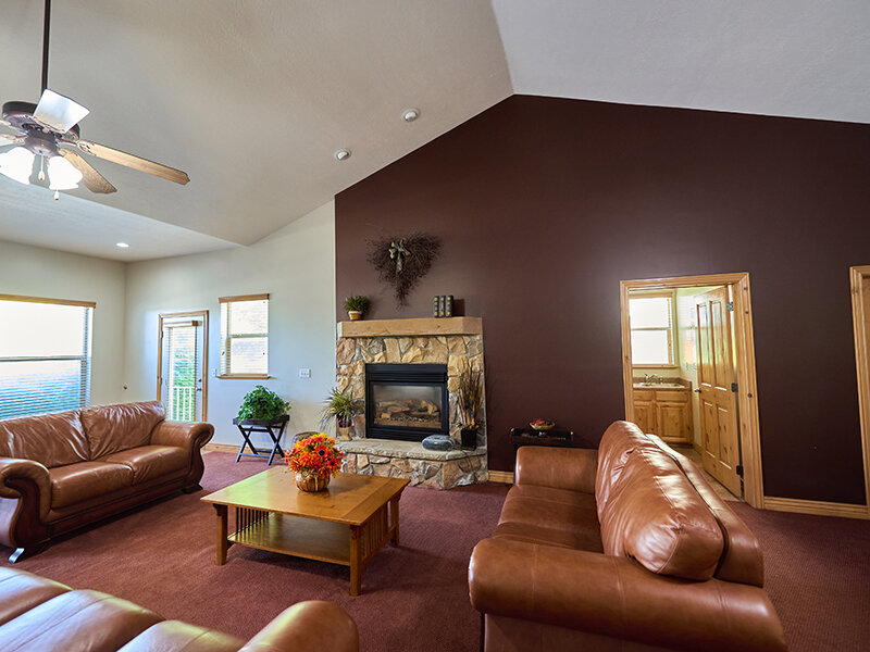 Community Clubhouse with Fireplace and Sofa's | Autumn Hills Apartments