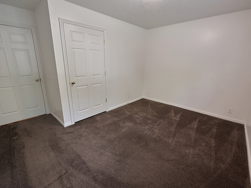 Bedroom with Closet Door and Carpeted Flooring | Autumn Hills Apartments