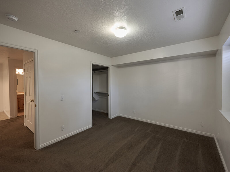 Apartment Bedroom with Open Door to Closet and Ceiling Light | Autumn Hills Apartments